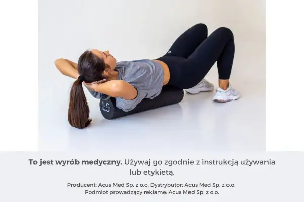 Kobieta z rękami za głową na wałku do masażu, rozluźnia spięte mięśnie pleców.